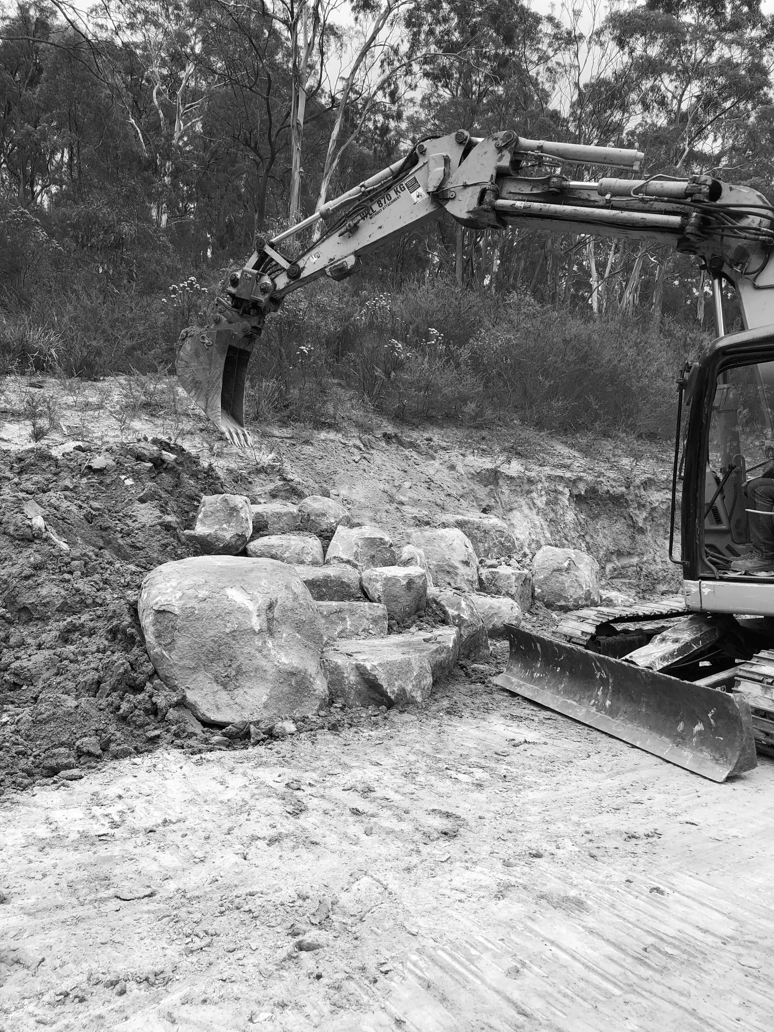 Excavator shaping the Swansong site