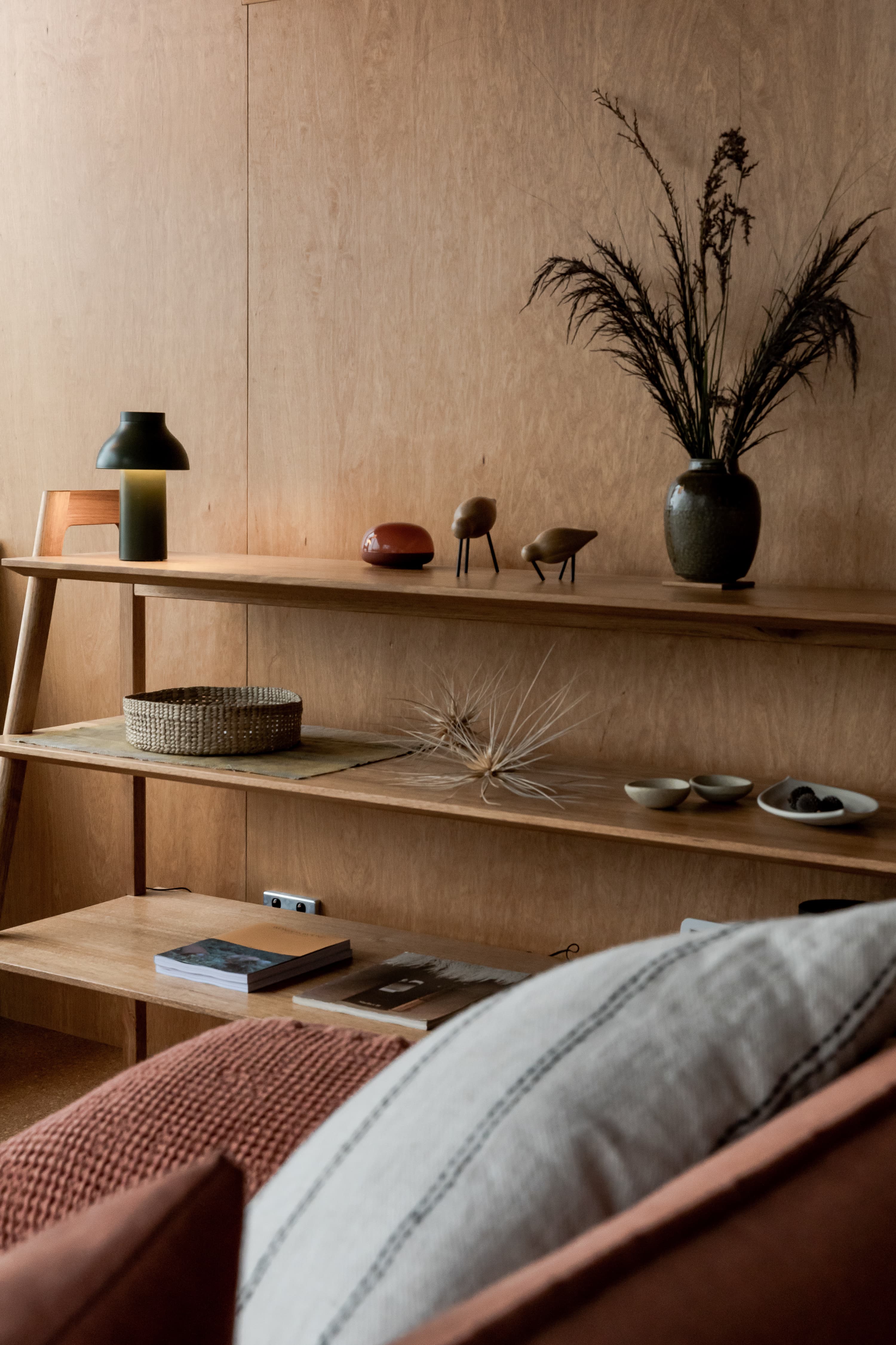 Timber shelf styled with ceramics, books and dried foliage